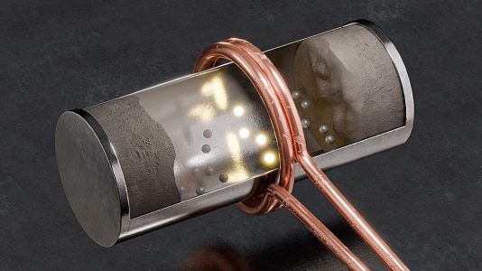 Funktionsschema der induktiven Beheizung eines Drehrohrreaktors bei der Zementherstellung: Um die schlechte elektrische Leitfähigkeit des Rohmaterials auszugleichen, werden sogenannte Suszeptoren hinzugefügt. Diese im Bild als Metallkugeln geformten Komponenten wandeln die mittels Induktion übertragene Energie effizient in Wärme um und verteilen sie gleichmäßig im Behältnis. Bild: HZDR / B.Schröder